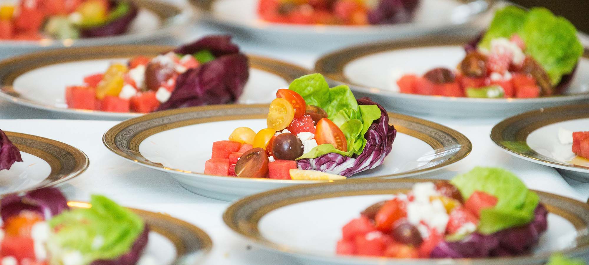 Spring salad on wedding tables with florals